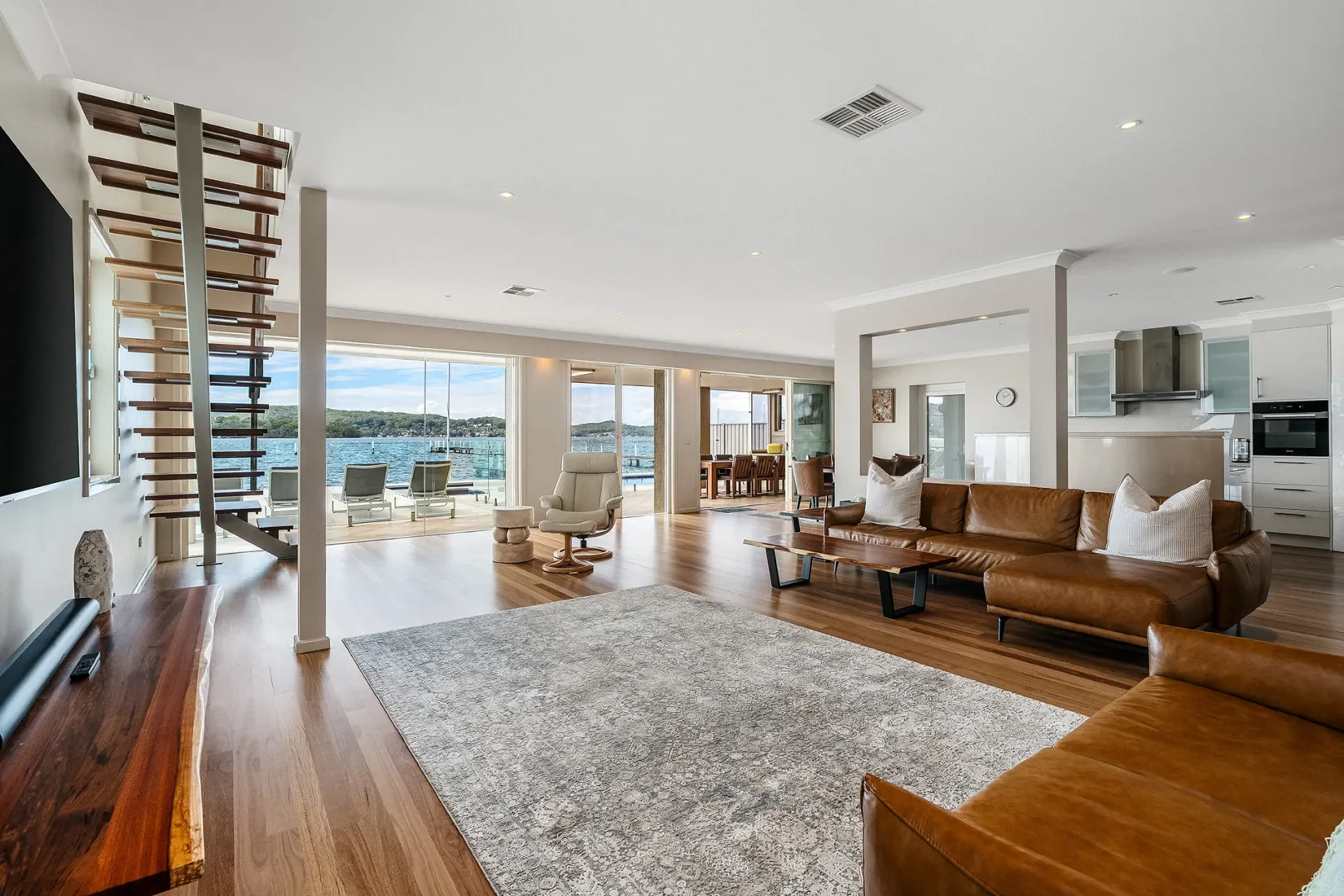 feature-stunning-open-lounge-area-overlooks-water-serene-point-clare-holiday-home-coasthosting