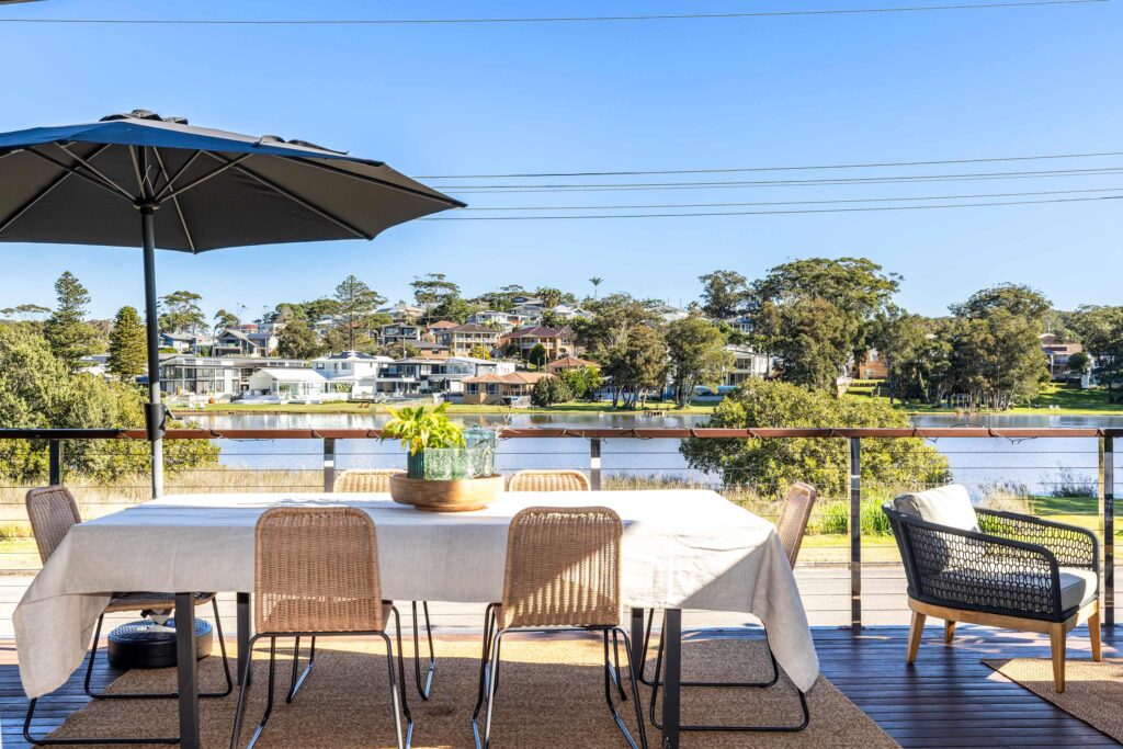 Wamberal Lagoon in the backyard. Terrigal Beach a five-minute walk. Welcome to Lake House. Lake House is a beautifully designed split-level home in Wamberal’s coveted Golden Triangle — a rare lakefront position with direct water access, a glass floor that stops guests mid-step, bi-fold doors opening to a covered lake-view terrace, and the golden sands of Terrigal Beach and the Esplanade café strip just five minutes on foot. For large families and groups who want the lake, the beach, and the best of Terrigal without ever needing the car, there is nowhere else like this on the Central Coast.